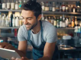 A restaurant manager uses an AI agent on a tablet to streamline operations.