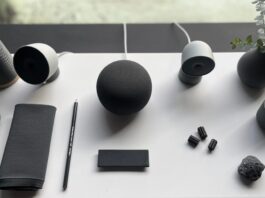 Google Home cameras, doorbell and speaker on a white table.