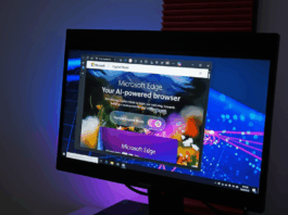 A computer monitor displaying the Microsoft Edge browser in Copilot Mode, with a dark background and blue and purple lighting.