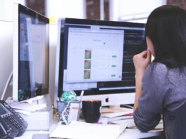woman sitting at computer using an AI tool