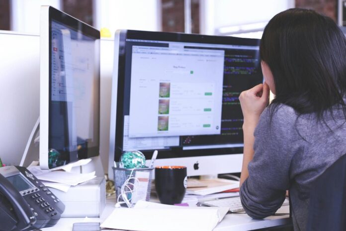 pexels-startup-stock-photos-7375.jpg woman sitting at computer using an AI tool