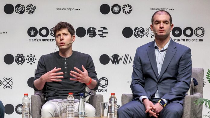 Sam Altman (left) and Ilya Sutskever (Right) sit in chairs on stage at an event.