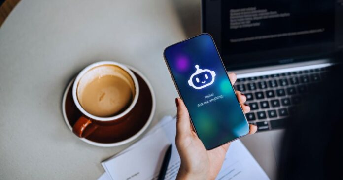 Overhead shot of businesswoman using AN AI chatbot virtual assistance app on smartphone to assist her while working on laptop - LancasterOnline