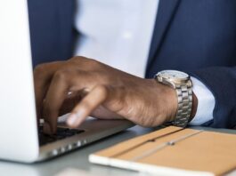 Man Typing on Laptop