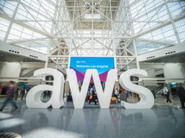 A large AWS company logo in an exhibition hall.