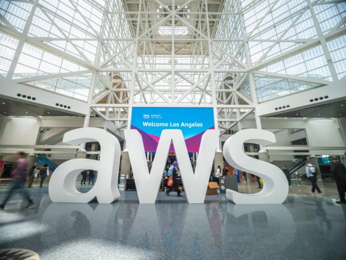A large AWS company logo in an exhibition hall.