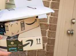 Amazon prime boxes and envelopes delivered to a front door of residential building