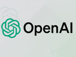 The OpenAI logo, featuring a green knot-like symbol to the left of the black text OpenAI, presented on a professional light gray background with a subtle, faded pattern of the logo.