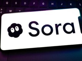 Sora logo on a smartphone resting on a laptop