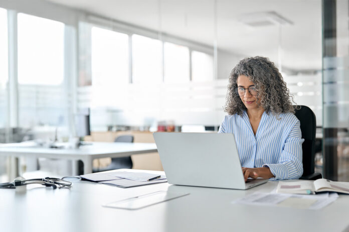 white-office-space-lady-in-specs-working-on-laptop.jpg KPMG Microsoft Alliance – MCP Use Cases