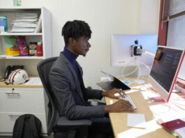 Post-doctoral researcher Tofunmi Omiye works in his office at the Stanford School of Medicine in Stanford, Calif., Tuesday, Oct. 17, 2023. A new study, co-led by Omiye, cautions that popular chatbots are perpetuating racist, debunked medical ideas, prompting concerns that the tools could worsen health disparities for Black patients. (AP Photo/Eric Risberg)