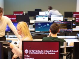 Students at the Gabelli School of Business study value investing in the trading room