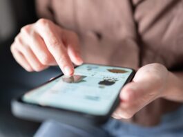 Woman's hands pointing to an item in an online shop on her smartphone, used in a post about FLIK