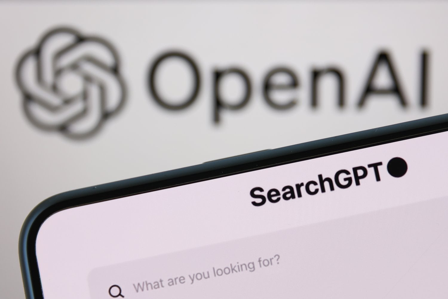 GettyImages-21653483551.jpg OpenAI logo displayed on a laptop screen and SearchGPT website displayed on a phone screen are seen in this illustration photo
