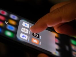 A photo of someone tapping AI apps on an iPhone.