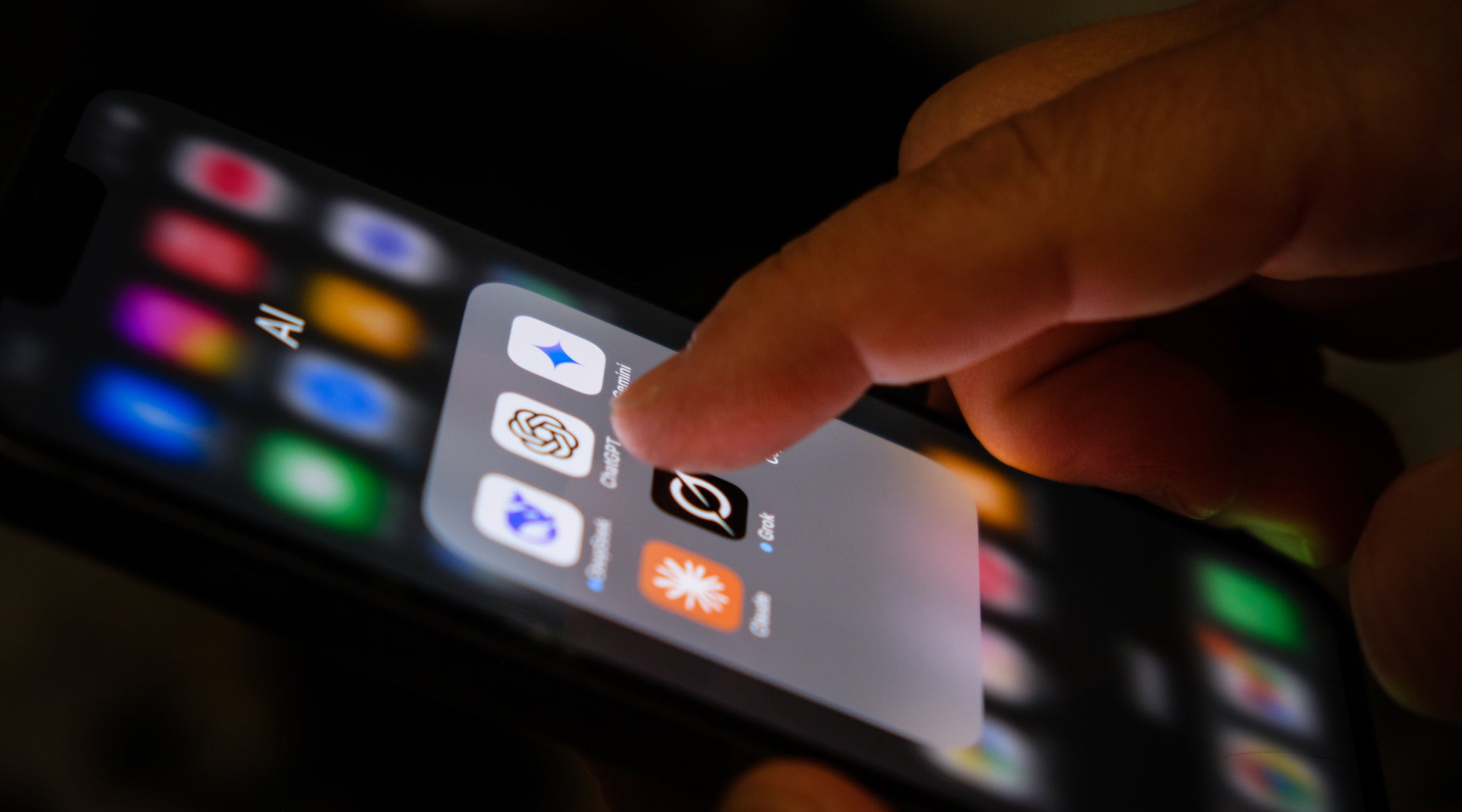 GettyImages-2214037506.jpg A photo of someone tapping AI apps on an iPhone.