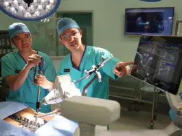 Adj A/Prof Jacob Oh (right), head of spine surgery and a senior consultant from the department of orthopedic surgery at TTSH, and Dr Wayne Yap, a consultant from the same department, demonstrating how the AI tool assisted the planning and execution of complex spine surgeries.