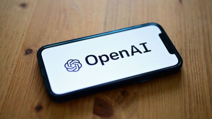 Logo of OpenAI, developer of the GPT-4.1 AI model family, pictured on a smartphone screen placed on a table.