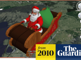 A 16:9 aspect ratio image of Santa Claus in his sleigh, with a green sack, flying over a landscape, as seen on a screen with navigation controls. The bottom right corner features a from 2010 The Guardian watermark.