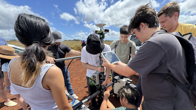 people working on agricultural equipment