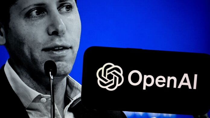 A black and white photo of Sam Altman, CEO at OpenAI, on a blue background with a phone bearing the OpenAI logo held in the foreground.