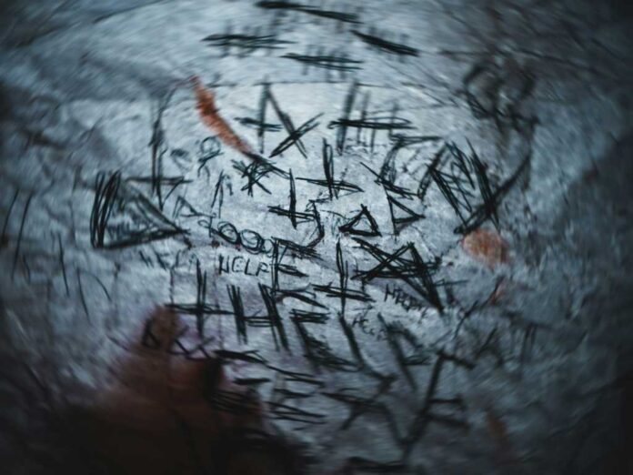 graffiti on the side of a building, meant to signify a nightmare