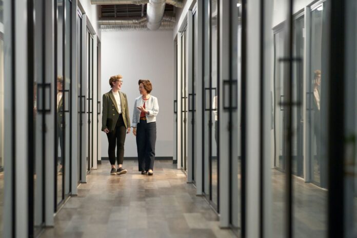 Two professionals collaborating in a modern, technology-enabled workplace.