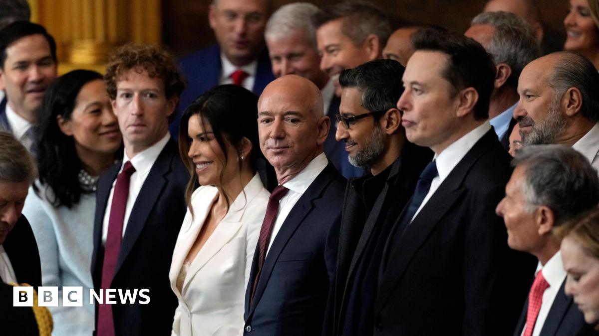 1413e9f0-23dd-11f1-934f-036468834728.jpg Appearing at the second inauguration of Donald Trump, from left to right: Mark Zuckerberg in a black suit, white dress shirt and red necktie; Jeff Bezos in a navy suit, white dress shirt and red neck tie; Sundar Pichai in an all black suit, shirt and neck tie; Elon Musk in a black suit, white dress shirt and navy neck tie