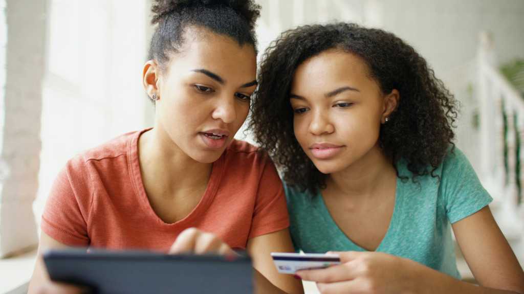 4137893-0-06006100-1772618573-vitaly-gariev-dc0SHStIZrg-unsplash.jpg image of women making online purchase