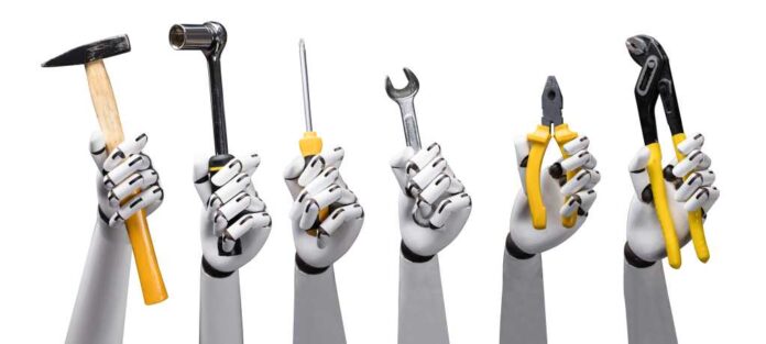 Close-up of robot hands holding tools on white background
