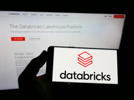 Databricks Loss: Person holding smartphone with logo of US company Databricks Inc. on screen in front of website