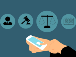 Navigating the New ABA Standards: Key Deliverables for Your Legal AI Tool Graphic depicting lawyer holding smartphone, various legal symbols in the air before the the lawyer. Graphic by Mohamed Hassan, via Pixabay.com.