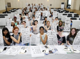International students hold up their brush calligraphy works during a traditional calligraphy experience session at the “2025 Pusan National University Summer School,” held on July 9, 2025 at Pusan National University in Geumjeong District, Busan.