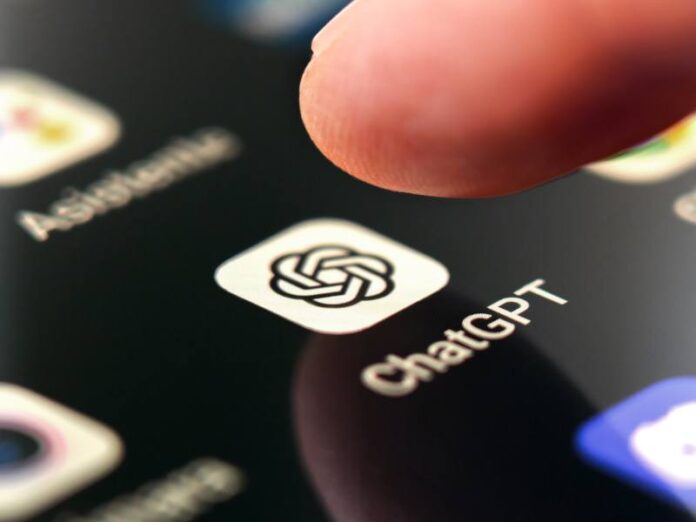 A finger touching the ChatGPT app on a smartphone screen.
