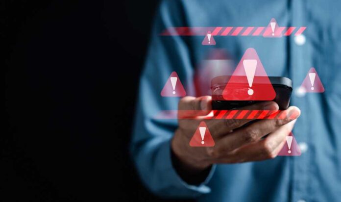 System warning caution sign on smartphone, scam virus attack on firewall for notification error and maintenance. Network security vulnerability, data breach, illegal connection and information danger.