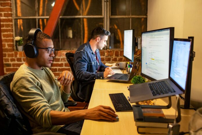 two people sitting at the computer